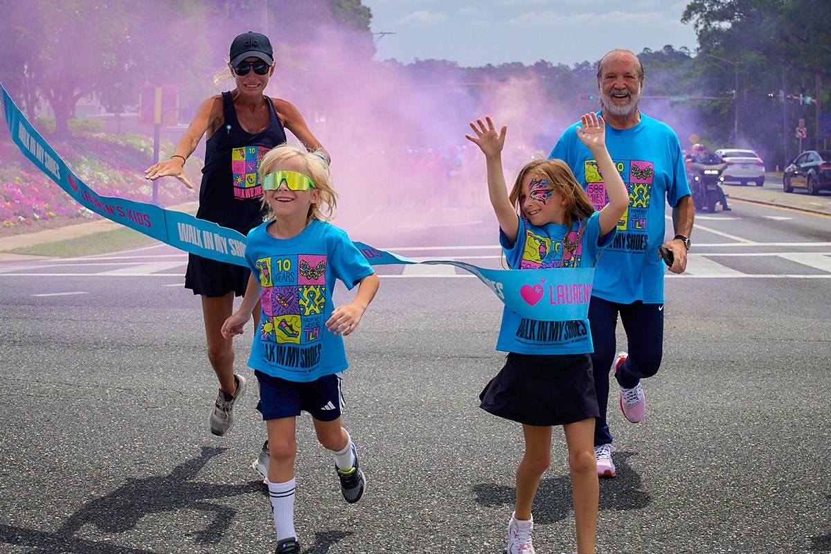 Kids and adults running through the finish line at Lauren's Kids walk.