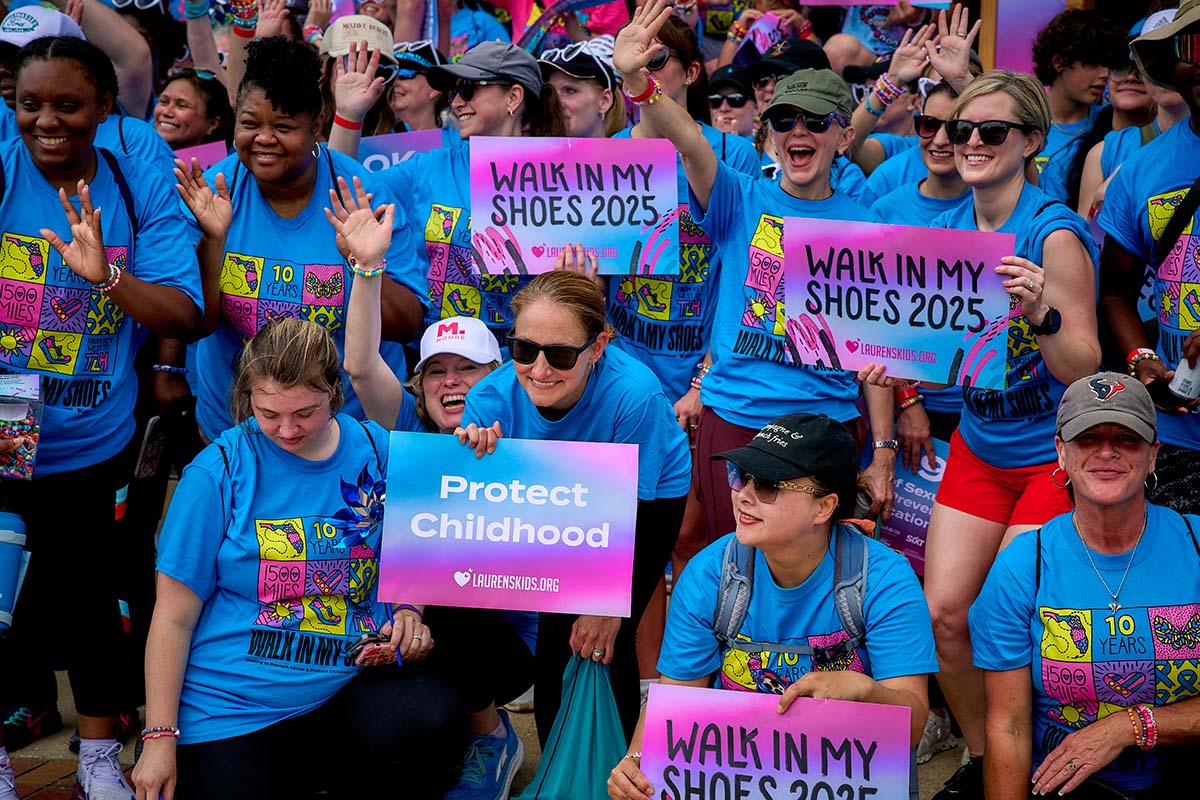 People with Walk in my shoes 2025 signs