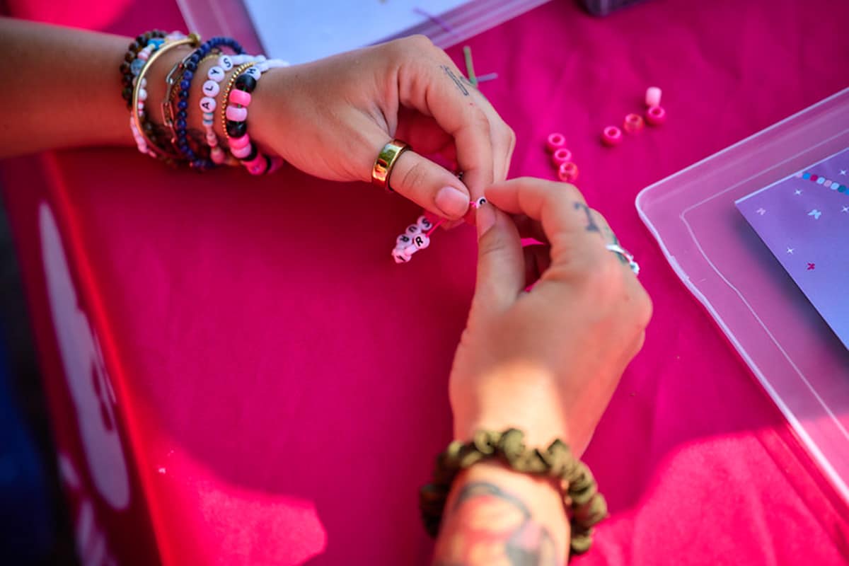 Woman making friendship bracelets