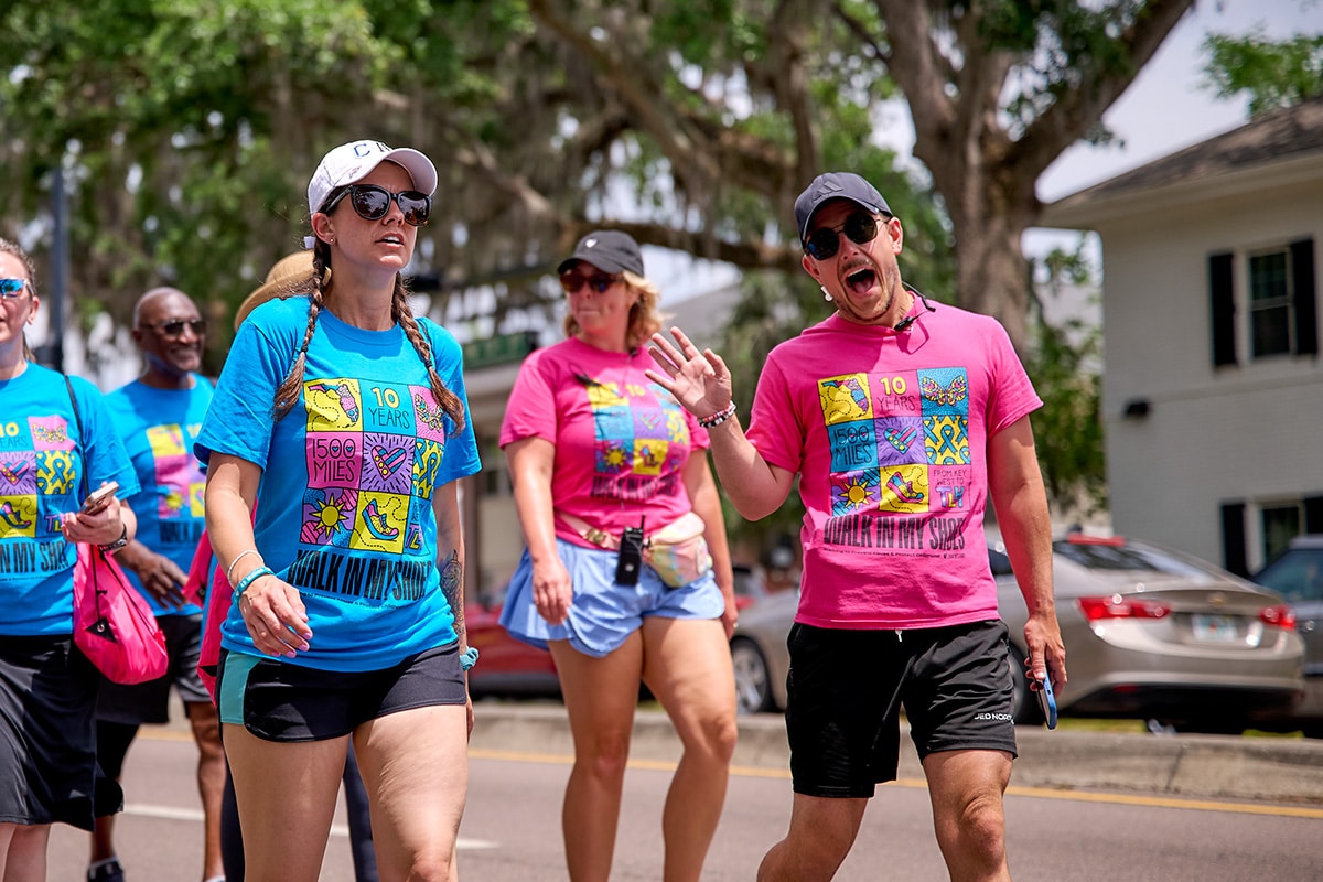 People on the walk smiling and waving
