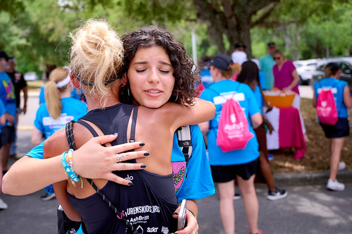 two women hugging at the Walk in my shoes walk