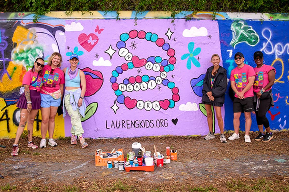 People standing in front of a mural during Lauren's kids walk