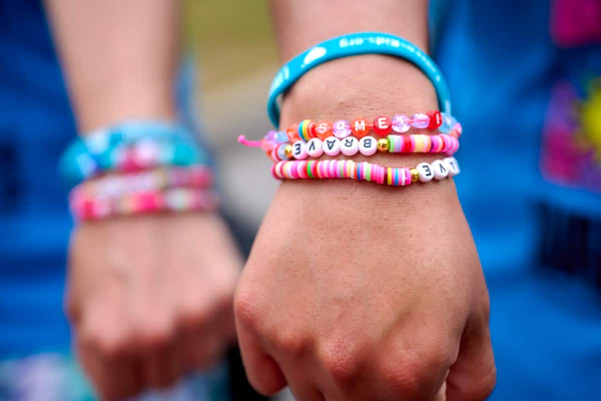 Friendship bracelets on two wrists